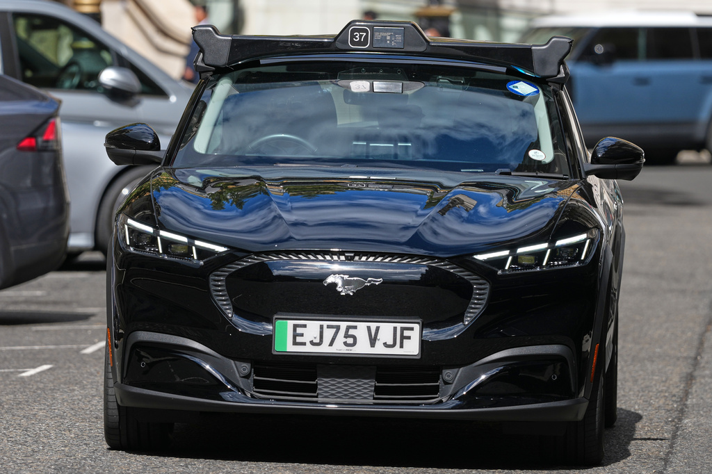 An autonomous car drives through the streets in Westminster, London, Tuesday, Sept. 1, 2026 as Uber officially launches the first hailable autonomous cabs in London.(AP Photo/Frank Augstein)