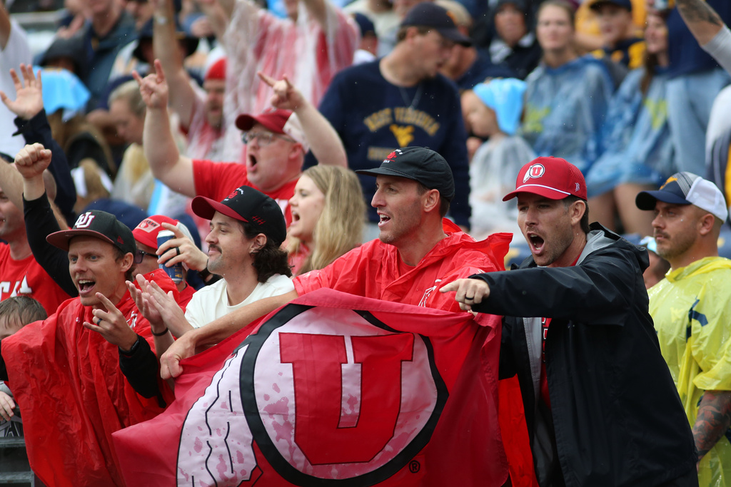 Utah fans react during the first half of an NCAA college football game against West Virginia, Saturday, Sept, 27, 2025, in Morgantown, W.Va. (AP Photo/ William Wotring)