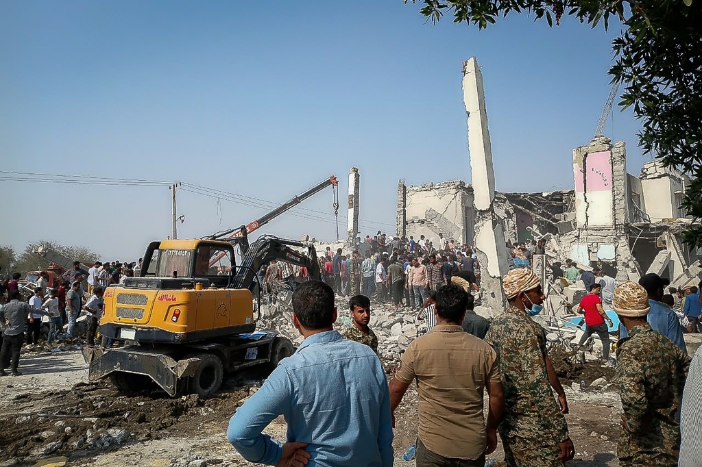 Rescue workers and residents search through the rubble in the aftermath of an Israeli-U.S. strike on a girls' elementary school in Minab, Iran, Saturday, Feb. 28, 2026. (ISNA via AP)