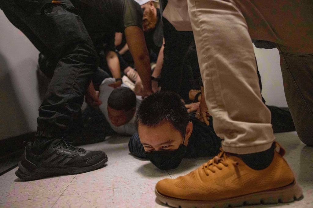 FILE - A Dominican man, left, and an activist, right, are detained by plainclothes officers with Immigration and Customs Enforcement after an immigration hearing at the immigration court inside the Jacob K. Javits Federal Building in New York, on June 6, 2025. (AP Photo/Yuki Iwamura, File)