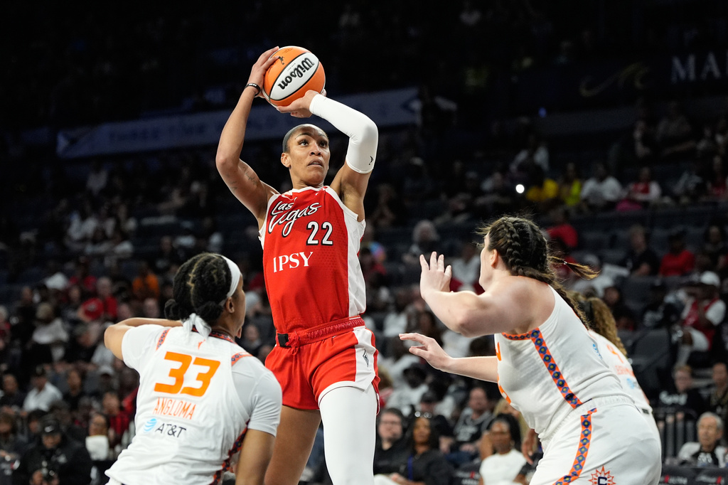 Las Vegas Aces center A'ja Wilson (22) shoots against the Connecticut Sun during the second half of a WNBA basketball game Thursday, Aug. 20, 2026, in Las Vegas. (AP Photo/John Locher)