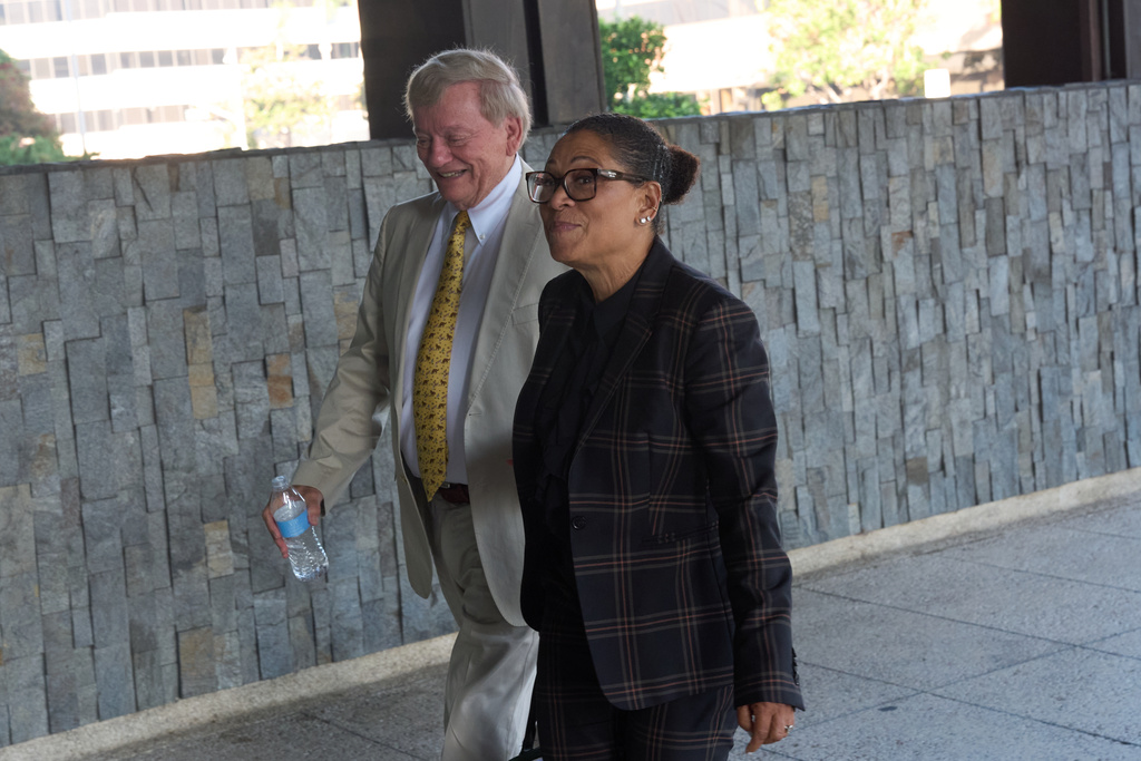 Shawn Holley, right, and Rusty Hardin, attorneys for the family of former baseball pitcher Tyler Skaggs, arrive during the trial for the wrongful death lawsuit accusing the Los Angeles Angels baseball team of being responsible for the 2019 drug overdose death of Skaggs Tuesday, Oct. 21, 2025, in Santa Ana, Calif. (AP Photo/Gregory Bull)