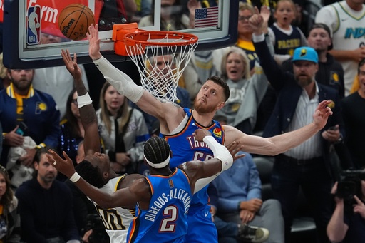 Indiana Pacers' Bennedict Mathurin (00) puts up a shot against Oklahoma City Thunder's Shai Gilgeous-Alexander (2) and Isaiah Hartenstein (55) during overtime of an NBA basketball game, Thursday, Oct. 23, 2025, in Indianapolis. (AP Photo/Darron Cummings) Indiana Pacers' Bennedict Mathurin (00) puts up a shot against Oklahoma City Thunder's Shai Gilgeous-Alexander (2) and Isaiah Hartenstein (55) during overtime of an NBA basketball game, Thursday, Oct. 23, 2025, in Indianapolis. (AP Photo/Darron Cummings)