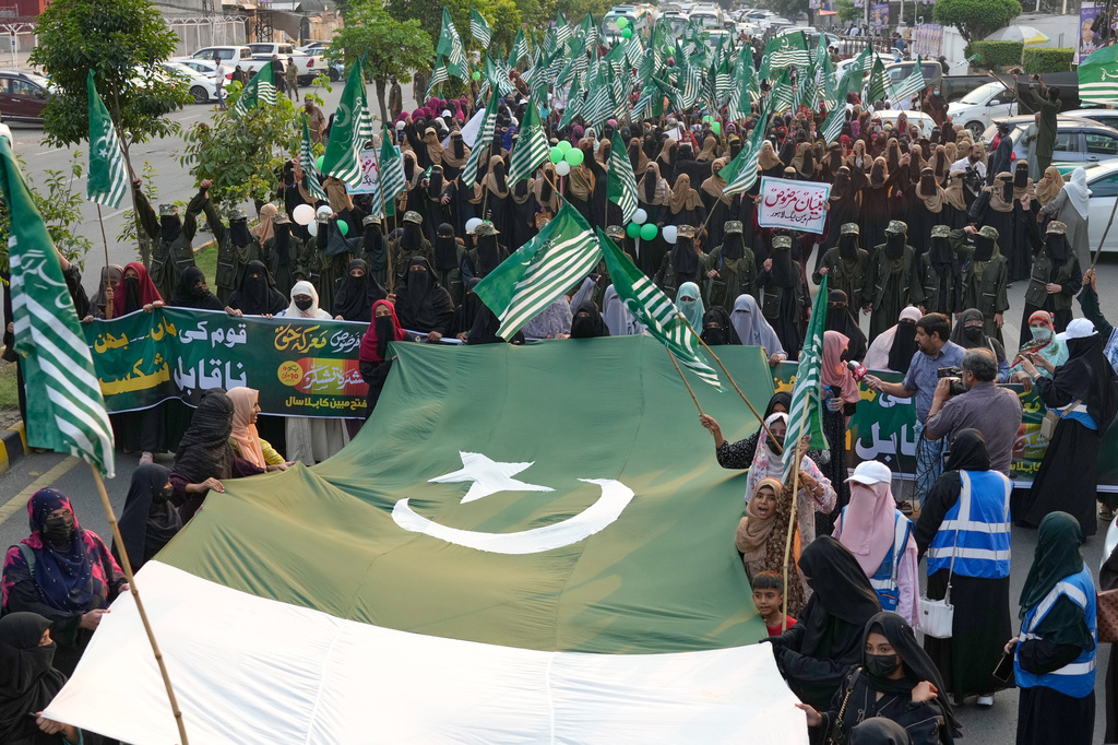 Supporters of the Muslim women league Pakistan, hold a giant Pakistani flag during a rally to mark the anniversary of last year's four-day conflict with neighboring India, Thursday, May 7, 2026, in Lahore, Pakistan. (AP Photo/K.M. Chaudary)