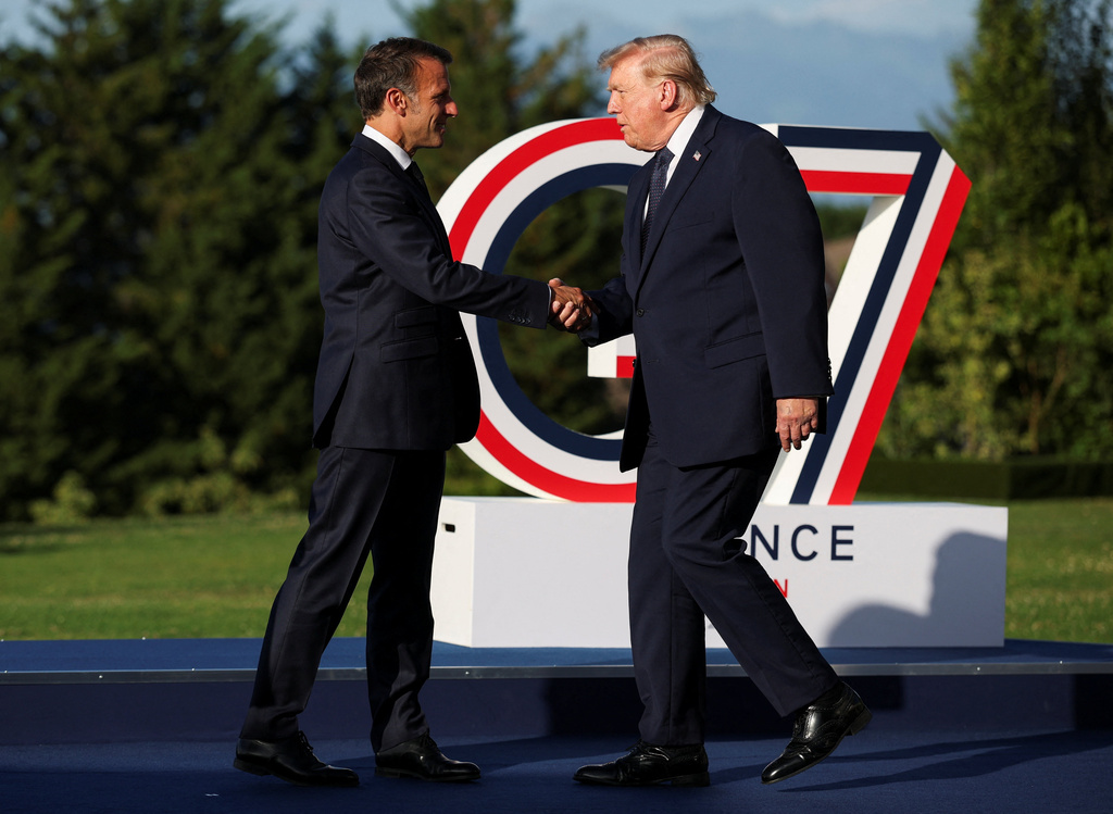 French President Emmanuel Macron greets President Donald Trump, right, during the official arrivals ceremony for the G7 summit in Evian-les-Bains, France, Monday, June 15, 2026. (Isabel Infantes, Pool Photo via AP)