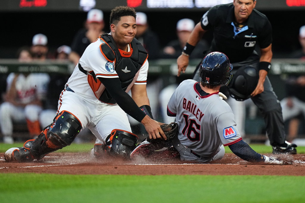 Baltimore Orioles catcher Samuel Basallo, left, tags Cleveland Guardians' Patrick Bailey (16) out at home plate during the second inning of a baseball game, Tuesday, Sept. 8, 2026, in Baltimore. (AP Photo/Stephanie Scarbrough)