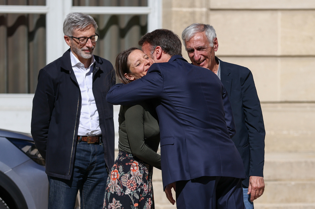 French President Emmanuel Macron, centre right, greets Cecile Kohler, a French national who was freed by Iran with Jacques Paris, right, after three and a half years in detention, next to French ambassador to Iran Pierre Cochard at the Elysee Palace in Paris, France, April 8, 2026. (Tom Nicholson/Pool Photo via AP)