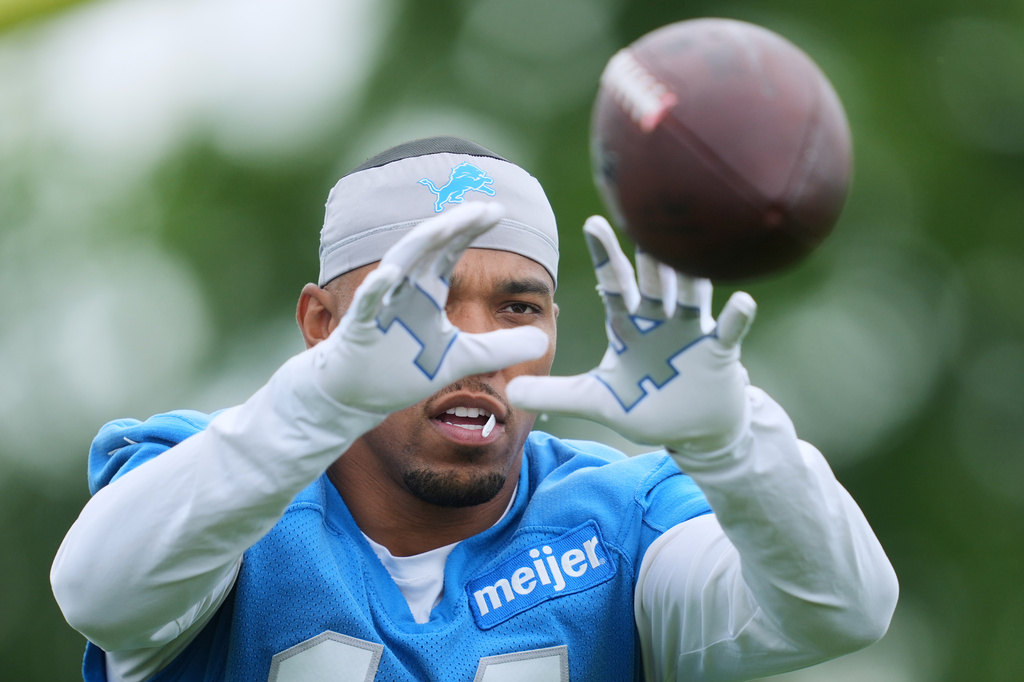 FILE - Detroit Lions wide receiver Amon-Ra St. Brown (14) catches a pass during an NFL football practice in Allen Park, Mich., June 11, 2026. (AP Photo/Paul Sancya, File)