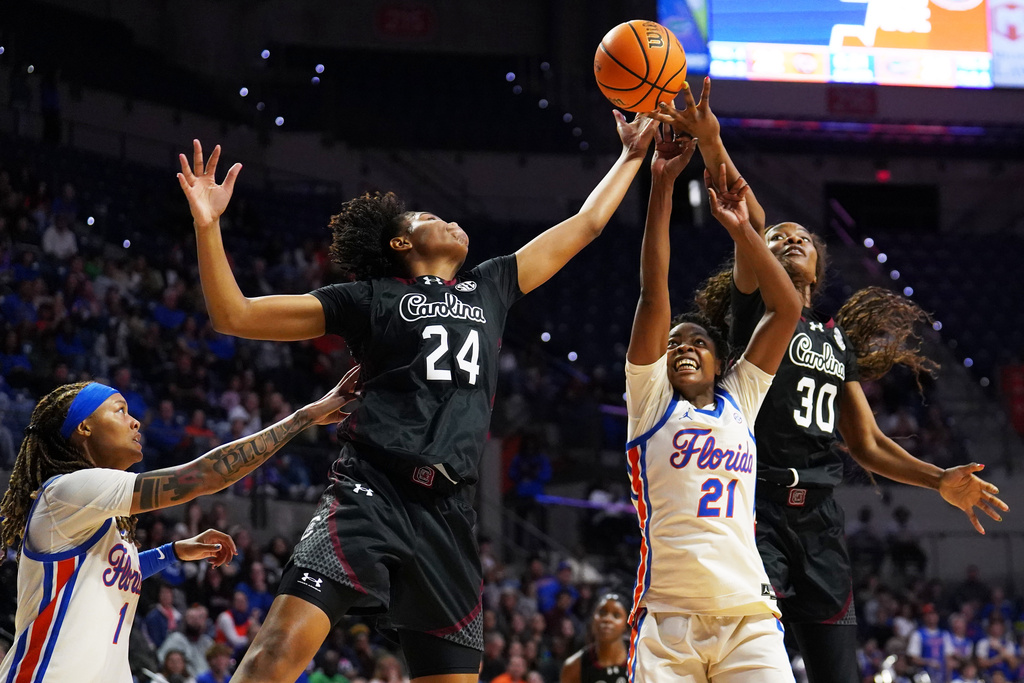 South Carolina guard Ayla McDowell, forward Maryam Dauda and Florida center Gift Ezekiel go for the rebound during the first half of an NCAA college basketball game Sunday, Jan. 4, 2026, in Gainesville, Fla. (AP Photo/Morgan Hurd)
