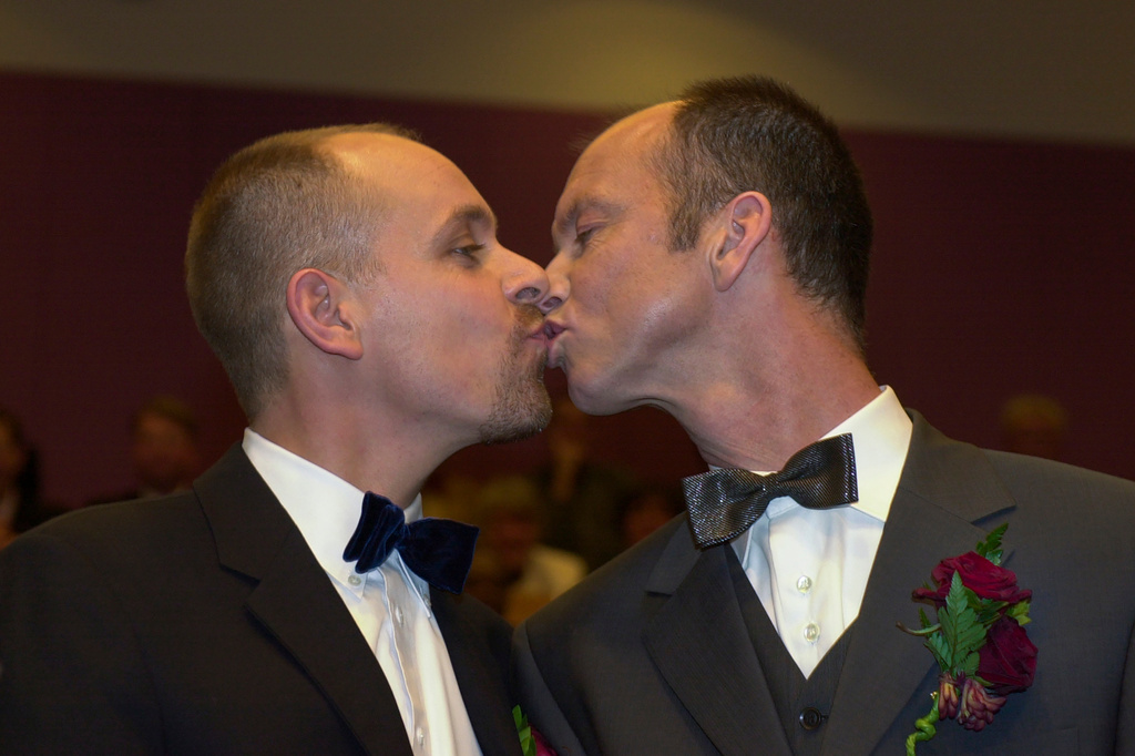 FILE -Gert Kasteel, left, and Dolf Pasker, who were among four couples to get married under the world's first law allowing same-sex marriages with equal rights, kiss after exchanging vows at Amsterdam's City Hall early April 1, 2001. (AP Photo/Peter Dejong, File)