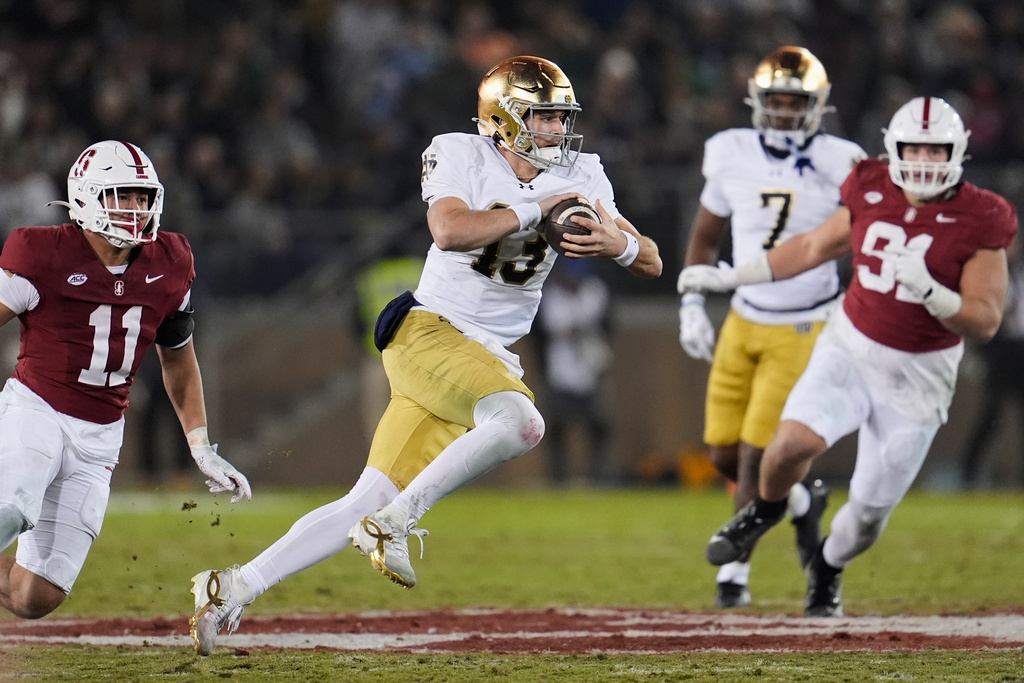 Notre Dame quarterback CJ Carr (13) runs with the ball during the first half of an NCAA college football game against Stanford, Saturday, Nov. 29, 2025, in Stanford, Calif. (AP Photo/Godofredo A. Vásquez)