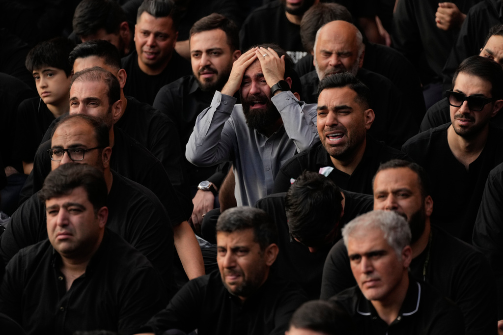 People weep during a mourning ceremony in Tehran, Iran, Thursday, June 18, 2026, ahead of Ashoura, which honors the 7th-century martyrdom of the Prophet Muhammad's grandson, Hussein, who was killed in a battle in Karbala in present-day Iraq. (AP Photo/Vahid Salemi)