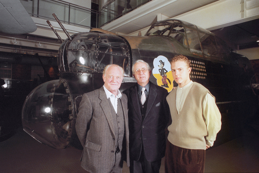 FILE - Author Len Deighton, center, poses for a photo with actors Frank Windsor, left and Sam West, who appear in a Radio 4 dramatisation of Len Deighton's book, "Bomber Harris", Feb. 8, 1995. (Sean Dempsey/PA via AP, File)