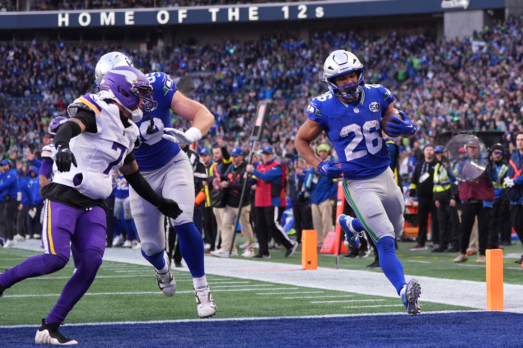 Seattle Seahawks running back Zach Charbonnet (26) runs for a touchdown against the Minnesota Vikings during the second half of an NFL football game, Sunday, Nov. 30, 2025, in Seattle. (AP Photo/Lindsey Wasson)