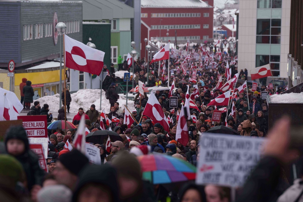 A crowd walks to the US consulate to protest against Trump's policy towards Greenland in Nuuk, Greenland, Saturday, Jan. 17, 2026. (AP Photo/Evgeniy Maloletka)
