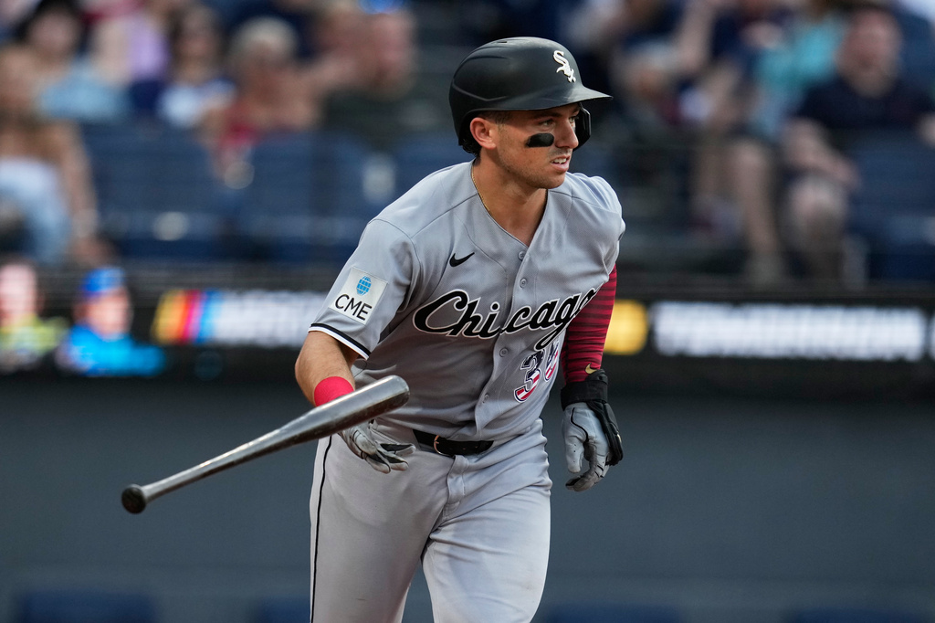 Chicago White Sox's Drew Romo tosses his bat as he heads to first base with a walk in the fourth inning of a baseball game against the Cleveland Guardians in Cleveland, Saturday, July 4, 2026. (AP Photo/Sue Ogrocki)