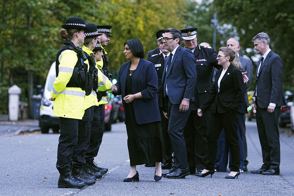 Britain's Home Secretary Shabana Mahmood, left, visits the scene following the incident at Heaton Park Hebrew Congregation synagogue in Crumpsall, Manchester, Thursday, Oct. 2, 2025. (Peter Byrne/PA via AP)