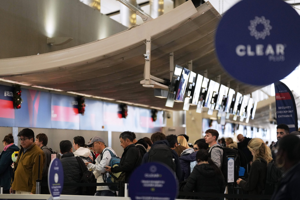 Travelers wait in a TSA checkpoint at Detroit Metropolitan Wayne County Airport Wednesday, Nov. 26, 2025, in Romulus, Mich. (AP Photo/Ryan Sun)