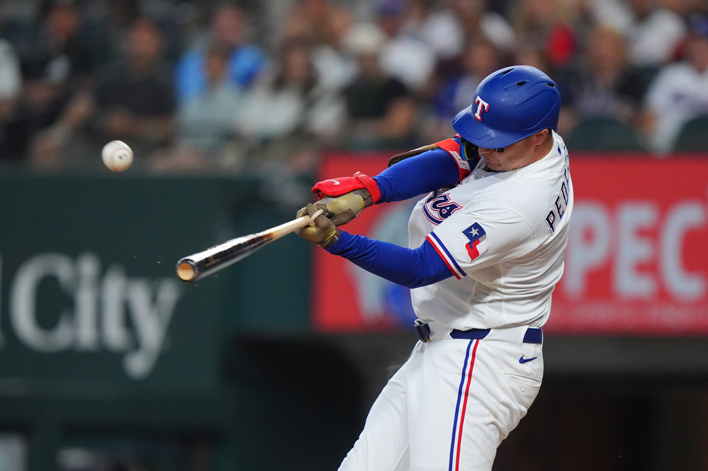 Texas Rangers designated hitter Joc Pederson hits a home run during the first inning of a baseball game against the Chicago White Sox, Monday, July 20, 2026, in Arlington, Texas. (AP Photo/LM Otero)