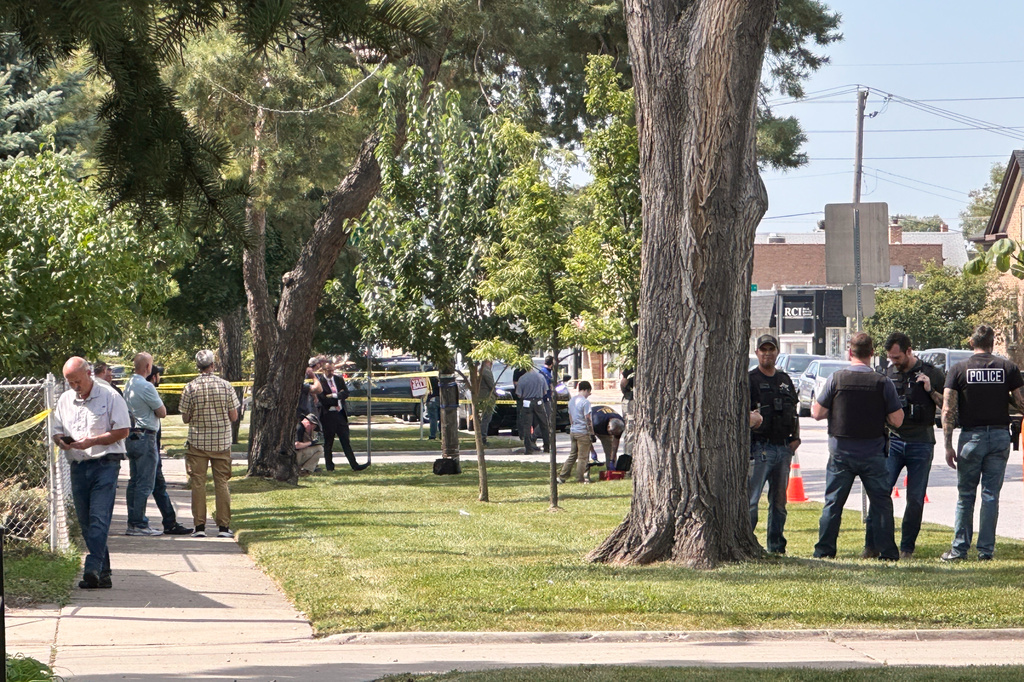Law enforcement responds to the scene where an Immigration and Customs Enforcement officer shot and killed a suspect after the suspect drove his car at the arresting officers on Friday, Sept. 12, 2025, in Franklin Park, Ill. (AP Photo/Laura Bargfeld)