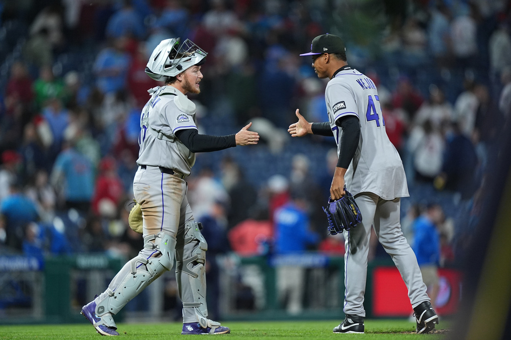 Colorado Rockies pitcher Juan Mejia and catcher Hunter Goodman celebrate after winning a baseball game against the Philadelphia Phillies, Friday, May 8, 2026, in Philadelphia. (AP Photo/Matt Rourke)