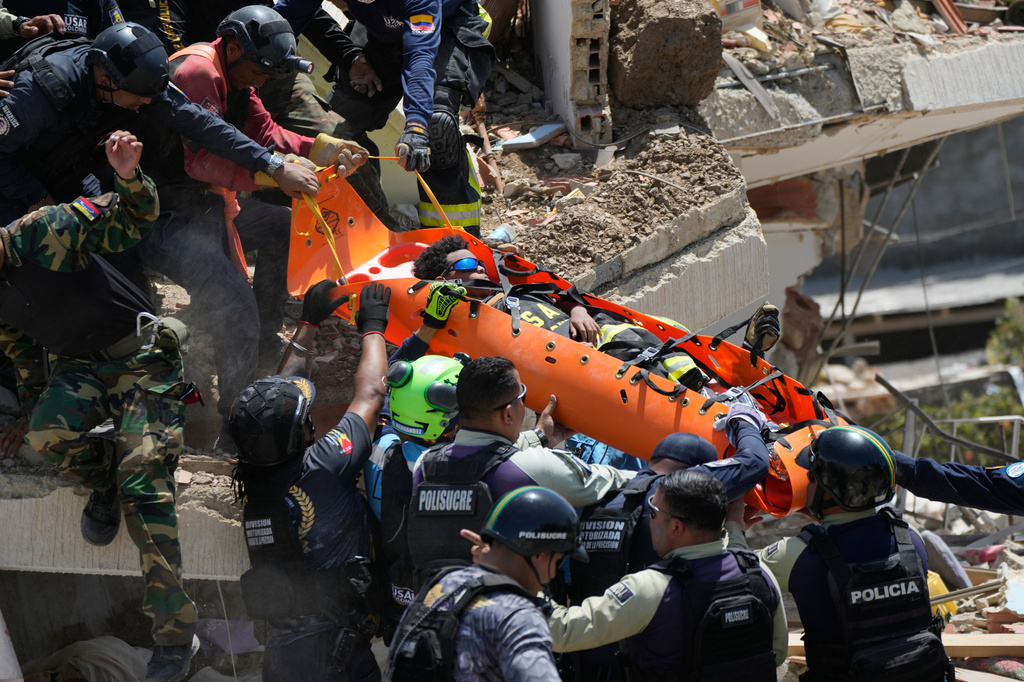 Rescue workers pull Moises Calzadilla, 11, from the rubble three days after earthquakes struck La Guaira, Venezuela, Saturday, June 27, 2026. (AP Photo/Fernando Vergara)