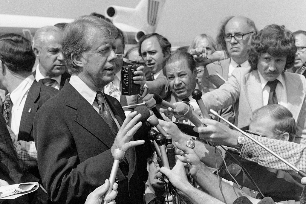 FILE - Democratic presidential nominee Jimmy Carter speaks to reporters on his arrival at Hobby International Airport in Houston Sept. 24, 1976. (AP Photo/Jack Thornell, File)