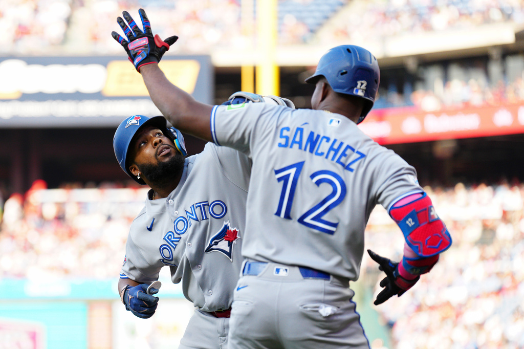 Toronto Blue Jays' Vladimir Guerrero Jr., left, celebrates with Jesús Sánchez (12) after hitting a solo home run off Philadelphia Phillies pitcher Aaron Nola during the first inning of a baseball game, Saturday, Aug. 8, 2026, in Philadelphia. (AP Photo/Derik Hamilton)