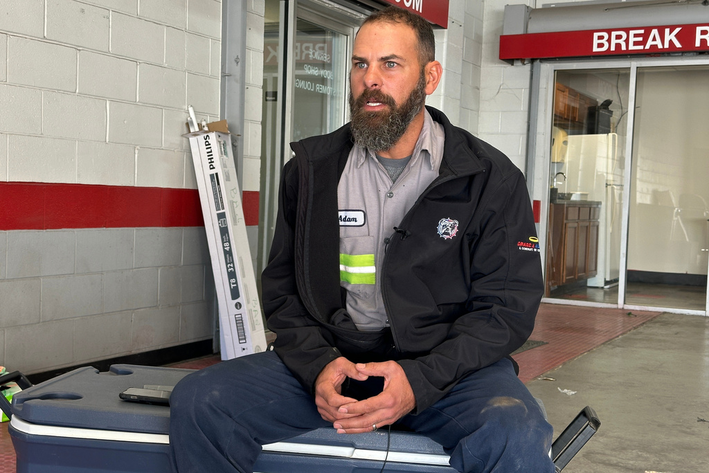 Adam Bowman, a supervisor at Grade A Auto Parts Recycling, is interviewed on Thursday, Nov. 13, 2025 in Louisville, Kentucky, about his actions after the UPS plane crash. (AP Photo/Dylan Lovan)