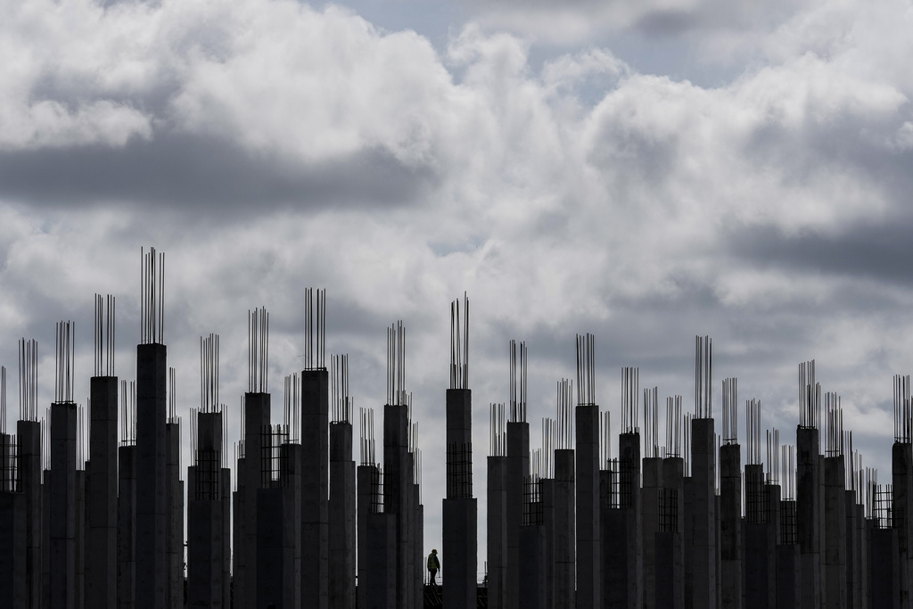 A worker walks through a building under construction in Georgetown, Guyana, Tuesday, Sept. 2, 2025. (AP Photo/Matias Delacroix)