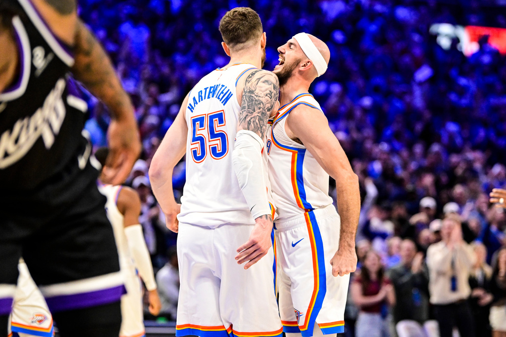 Oklahoma City Thunder guard Alex Caruso (9), right, celebrates with Oklahoma City Thunder center/forward Isaiah Hartenstein (55) during the second half of an NBA basketball game between Sacramento Kings and Oklahoma City Thunder, Tuesday, Oct. 28, 2025, in Oklahoma City. (AP Photo/Gerald Leong)