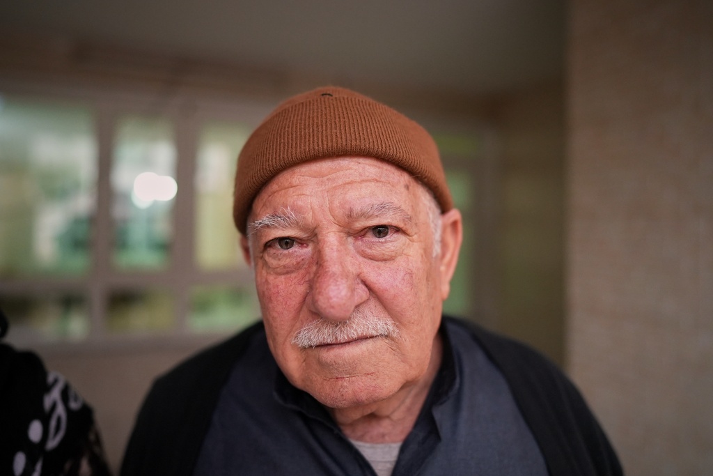 Syrian refugee Abdulilah Amin Dawoud, 73, poses for a picture at his home in Irbil, Iraq, Nov. 16, 2025. (AP Photo/Farid Abdulwahed)