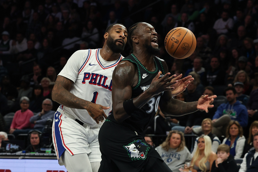 Minnesota Timberwolves forward Julius Randle (30) is fouled by Philadelphia 76ers center Andre Drummond (1) during the first half of an NBA basketball game Sunday, Feb. 22, 2026, in Minneapolis. (AP Photo/Stacy Bengs)