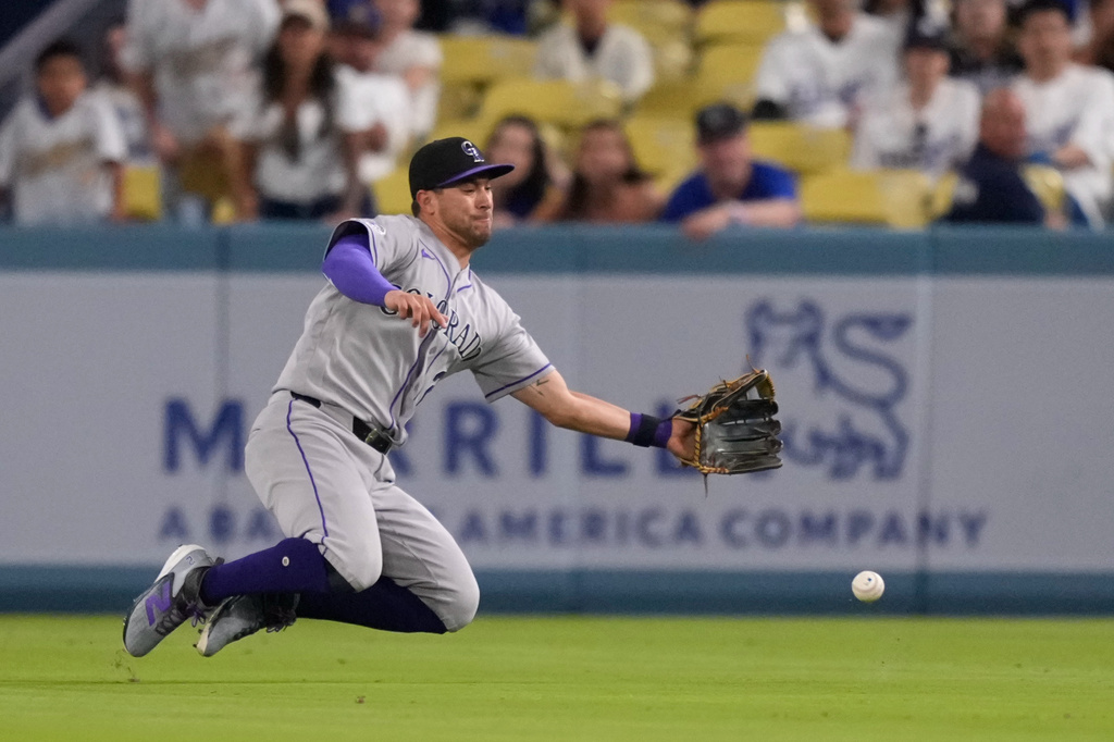Colorado Rockies right fielder Troy Johnston can't handle a ball hit for a single by Los Angeles Dodgers' Tommy Edman during the eighth inning of a baseball game Wednesday, July 8, 2026, in Los Angeles. (AP Photo/Mark J. Terrill)