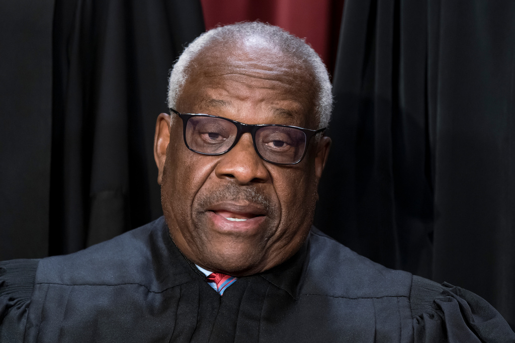 FILE - Supreme Court Associate Justice Clarence Thomas joins other members of the Supreme Court as they pose for a new group portrait, at the Supreme Court building in Washington, Oct. 7, 2022. Thomas was nominated by President George H. W. Bush to succeed Justice Thurgood Marshall and has served since 1991. (AP Photo/J. Scott Applewhite, File)