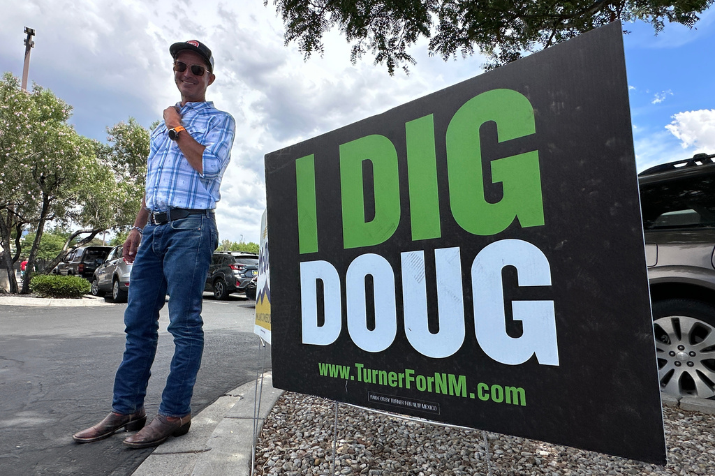 Republican gubernatorial candidate Doug Turner finds a shady spot as he greets voters in Albuquerque, N.M., on Tuesday, June 2, 2026. (AP Photo/Susan Montoya Bryan)