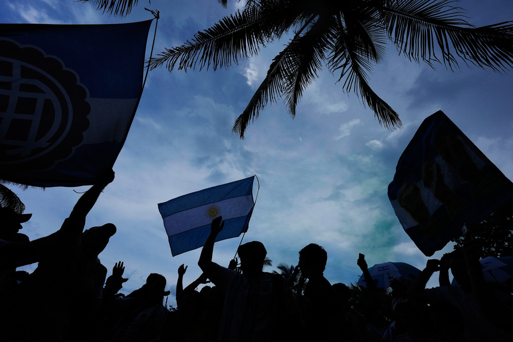 Argentina fans wave flags as they gather to celebrate and cheer on their team at a beachfront park in Miami Beach, Fla., Thursday, July 2, 2026, one day ahead of their World Cup round of 32 soccer match against Cape Verde. (AP Photo/Rebecca Blackwell)