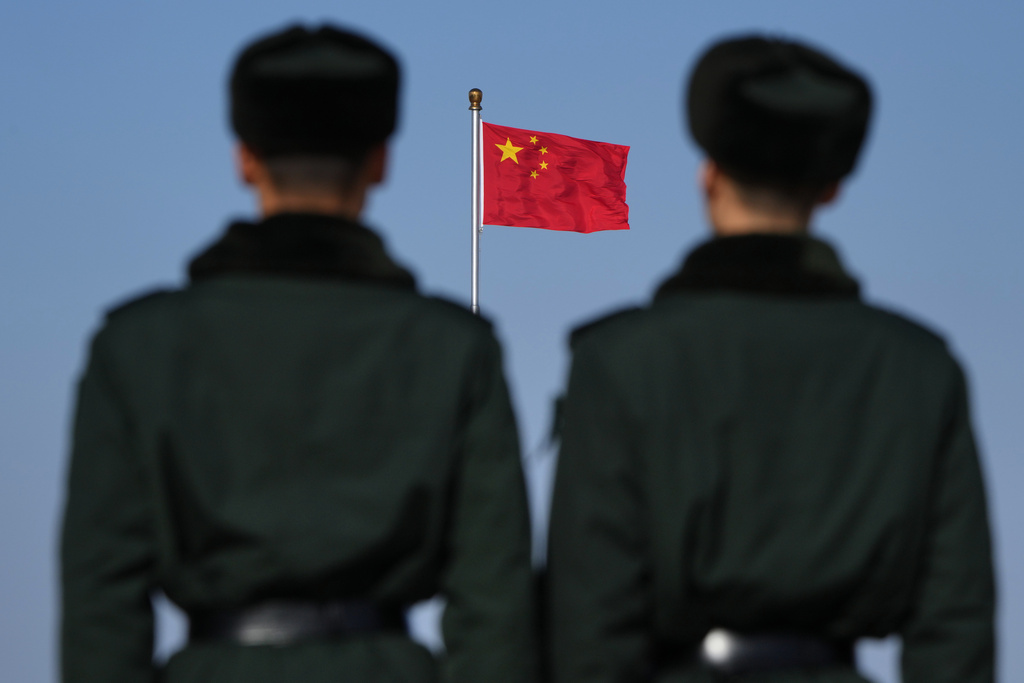 Soldiers stand watch against the national flag on Tiananmen Square during a press conference ahead of the opening of the Chinese People's Political Consultative Conference (CPPCC) held at the Great Hall of the People in Beijing, China, Tuesday, March 3, 2026. (AP Photo/Andy Wong)