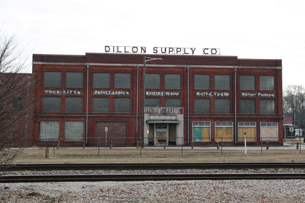 Railroad tracks cut through downtown Rocky Mount, N.C., Thursday, Dec. 18, 2025, with a boarded up building in the background. (AP Photo/Makiya Seminera)