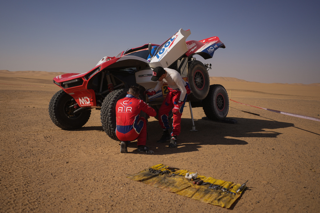 Driver Simon Vitse and co-driver Max Delfino check their car at the end of the ninth stage of the Dakar Rally between Wadi Ad Dawasir and Bisha, Saudi Arabia, Tuesday, Jan.13, 2026. (AP Photo/Thibault Camus)