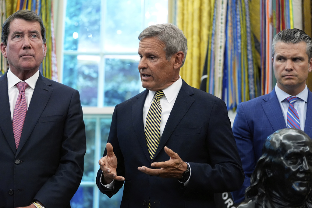 Tennessee Gov. Bill Lee speaks as Sen. Bill Hagerty, R-Tenn., left, and Defense Secretary Pete Hegseth listen during a memorandum singing with President Donald Trump in the Oval Office of the White House, Monday, Sept. 15, 2025, in Washington. (AP Photo/Alex Brandon)