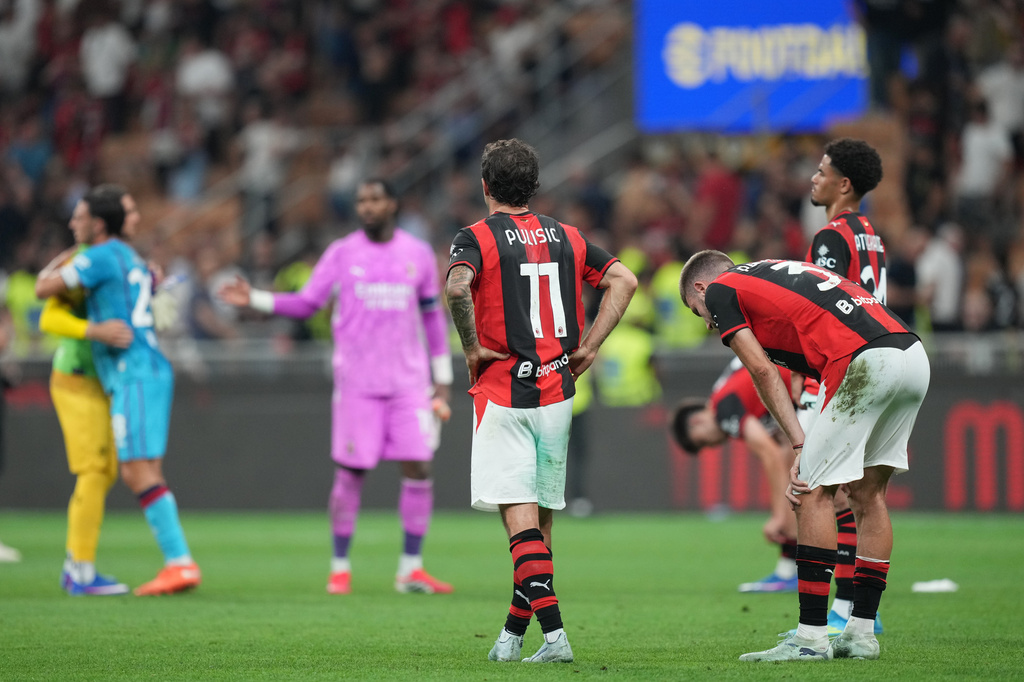 AC Milan's Christian Pulisic, left, reacts with his teammates Strahinja Pavlovic, center, and Zachary Athekame at the end of the Serie A soccer match between AC Milan and Cagliari, in Milan, Italy, Sunday, May 24, 2026. (AP Photo/Antonio Calanni)