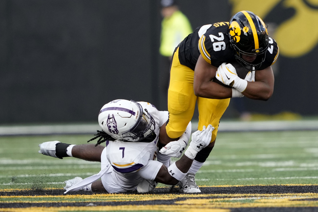 Iowa running back Xavier Williams (26) is tackled by Albany defensive back Thomas Joe-Kamara (7) during the first half of an NCAA college football game, Saturday, Aug. 30, 2025, in Iowa City, Iowa. (Photo by Charlie Neibergall)