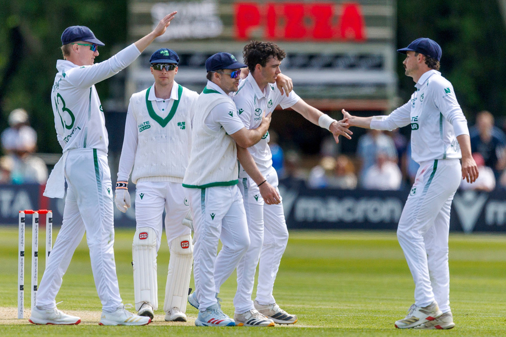 Ireland's Reuben Wilson, second right, is congratulated by teammates after bowling New Zealand's Tom Blundell on day two of the test match between Ireland and New Zealand at Stormont Cricket Ground in Belfast, Northern Ireland, Thursday May 28, 2026. (Liam McBurney/PA via AP)