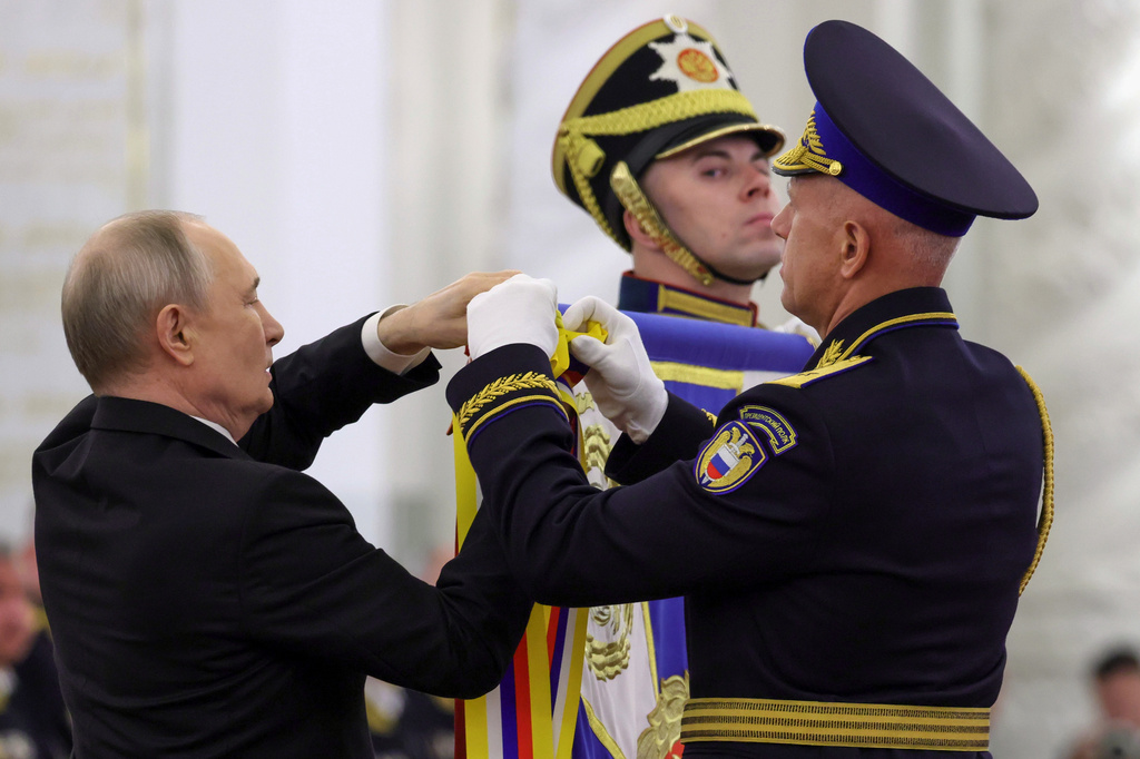 Russian President Vladimir Putin, left, and Commander of the Presidential Regiment Maj. Gen. Mikhail Suraikin, right, attend a ceremony to present the Order of Zhukov to the Presidential Regiment of the Russian Federal Guard Service at the Kremlin's St. George Hall in Moscow, Tuesday, June 23, 2026. (Mikhail Metzel/Sputnik, Kremlin Pool Photo via AP)