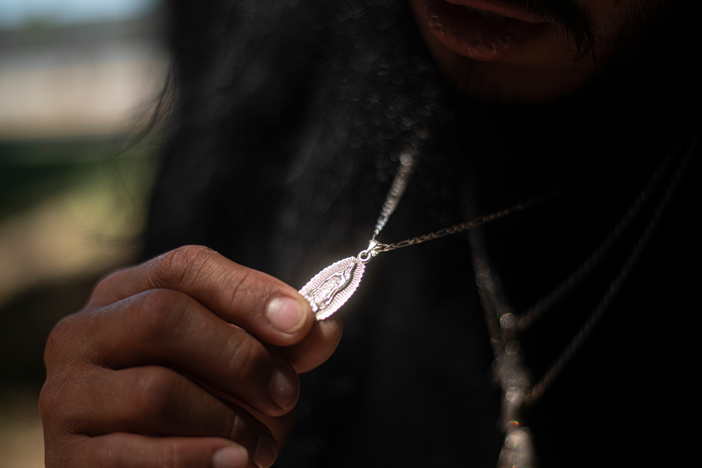 Gabriel Martinez Garcia, 30, holds a Hail Mary necklace given to him by his mother, which he wears every day, in Tenino, Wash., on Sunday, June 14, 2026. (AP Photo/Akash Pamarthy)