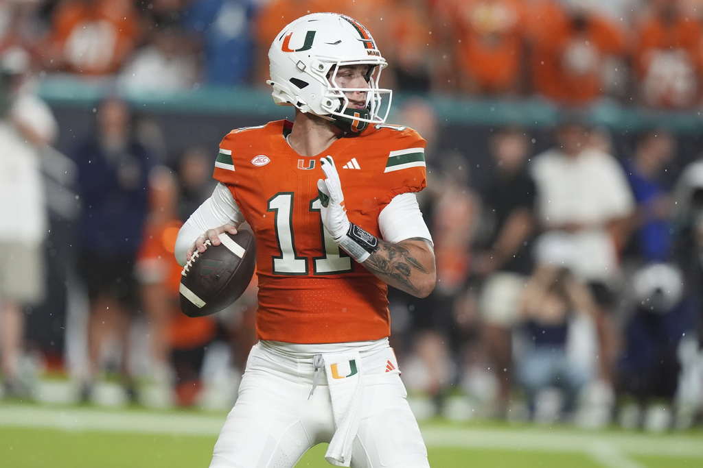 Miami quarterback Carson Beck (11) stands back to pass during the first half of an NCAA college football game against Notre Dame, Sunday, Aug. 31, 2025, in Miami Gardens, Fla. (AP Photo/Lynne Sladky)