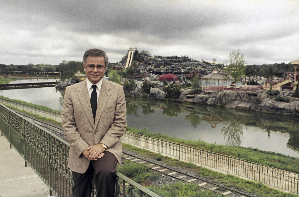 FILE - Television evangelist Jim Bakker poses in front of the Water Park in Columbia, SC, one of the attractions at his Heritage USA, March 19, 1987. (AP Photo/Lou Krasky, File)