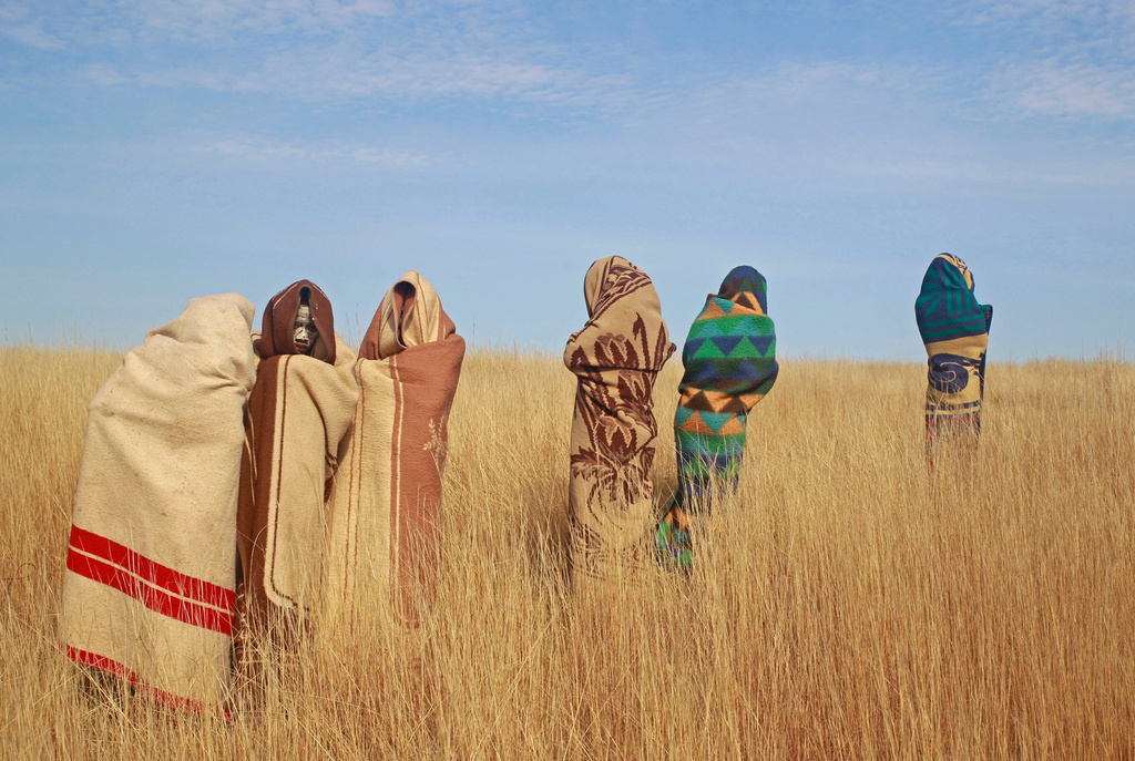 FILE - Xhosa boys stand in a field during traditional Xhosa male circumcision ceremonies into manhood in Qunu, South Africa, on Saturday, June 30, 2013. (AP Photo/Schalk van Zuydam, File)
