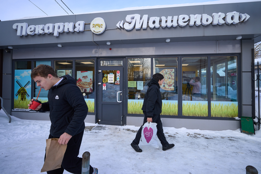People exit the Mashenka bakery outside Moscow, Russia, Wednesday, Feb. 18, 2026. (AP Photo/Alexander Zemlianichenko)